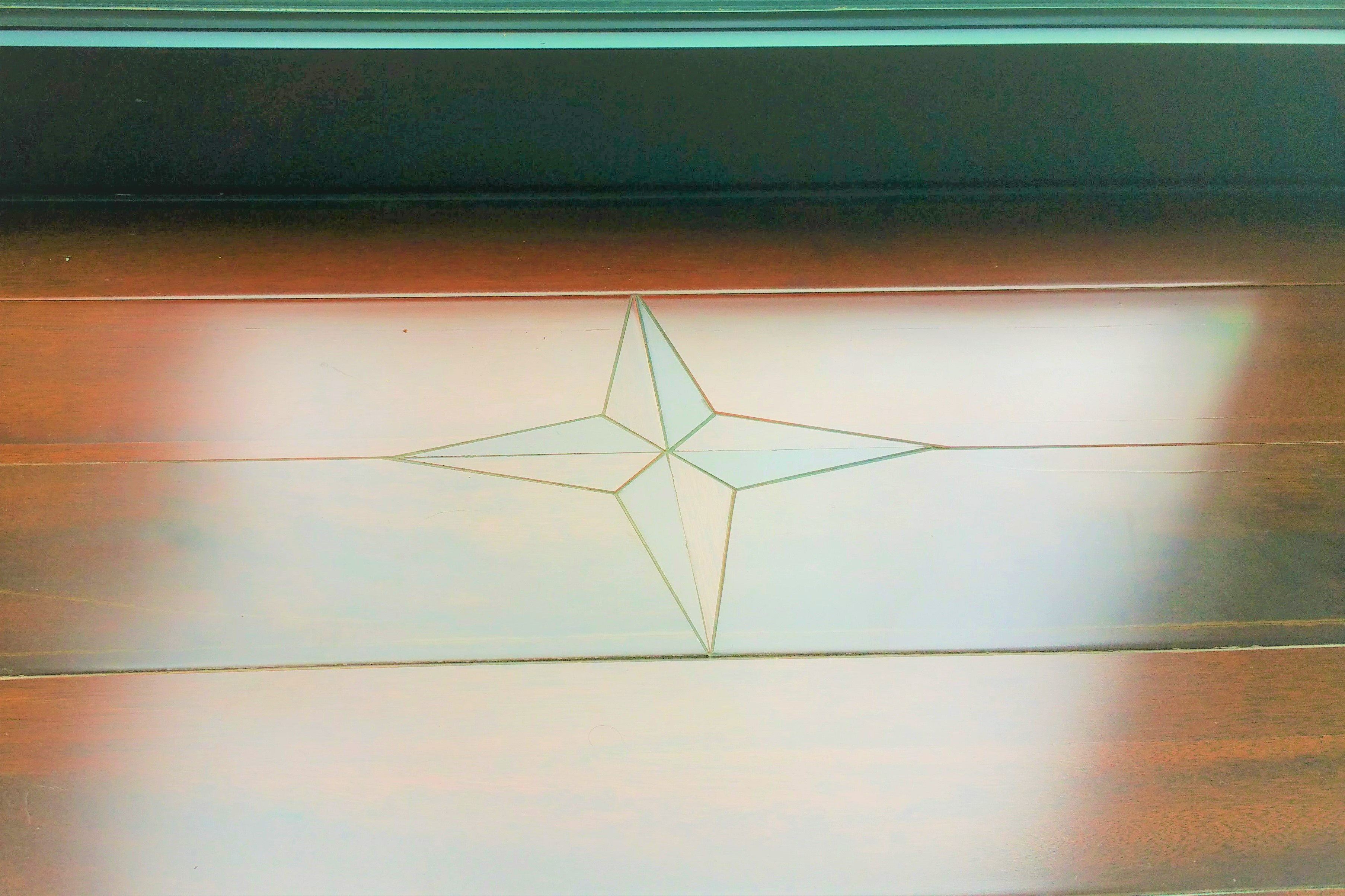 Hardwood decking with compass star inlay