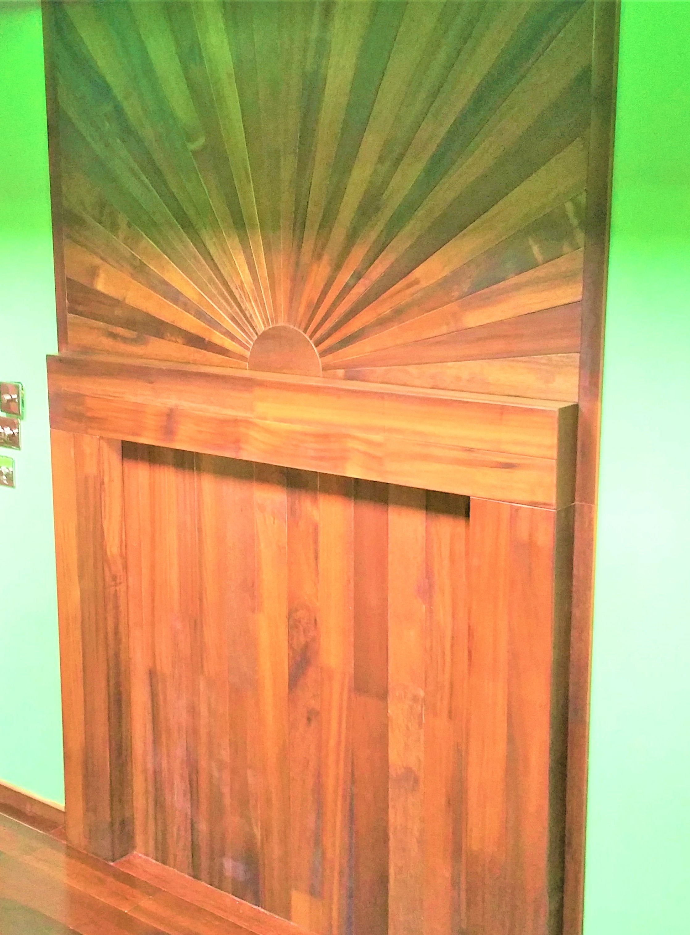 Full perspective of the Art Deco sunburst mantelpiece in the room setting